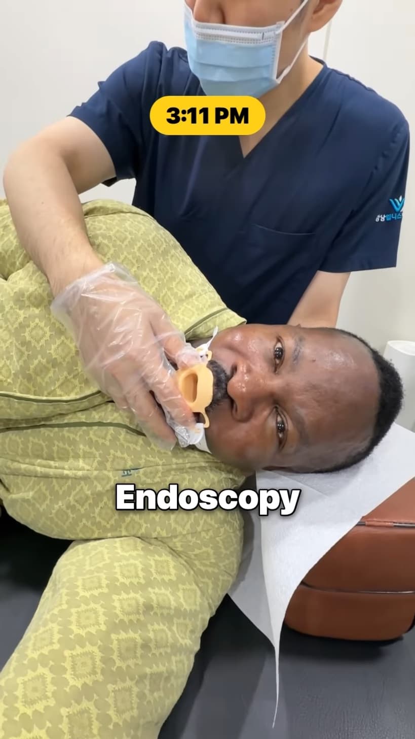 A gastroenterologist placing a mouthpiece before an upper endoscopy.