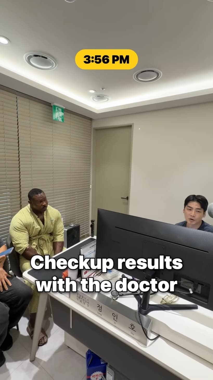 Chef Rush in a checkup gown going over results with the doctor.