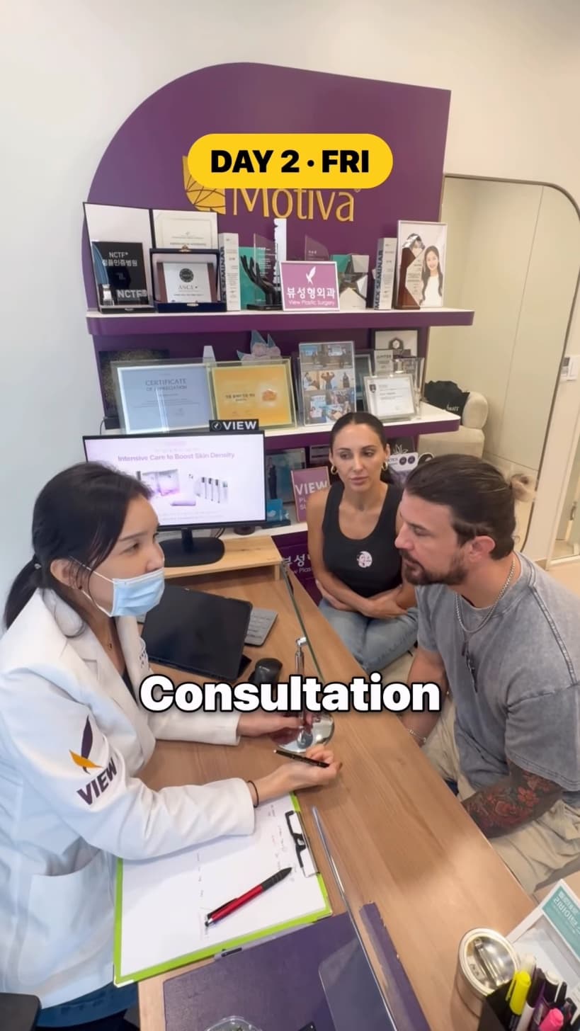 A doctor at View Plastic Surgery consulting with Kyle Istook and his partner across a desk.