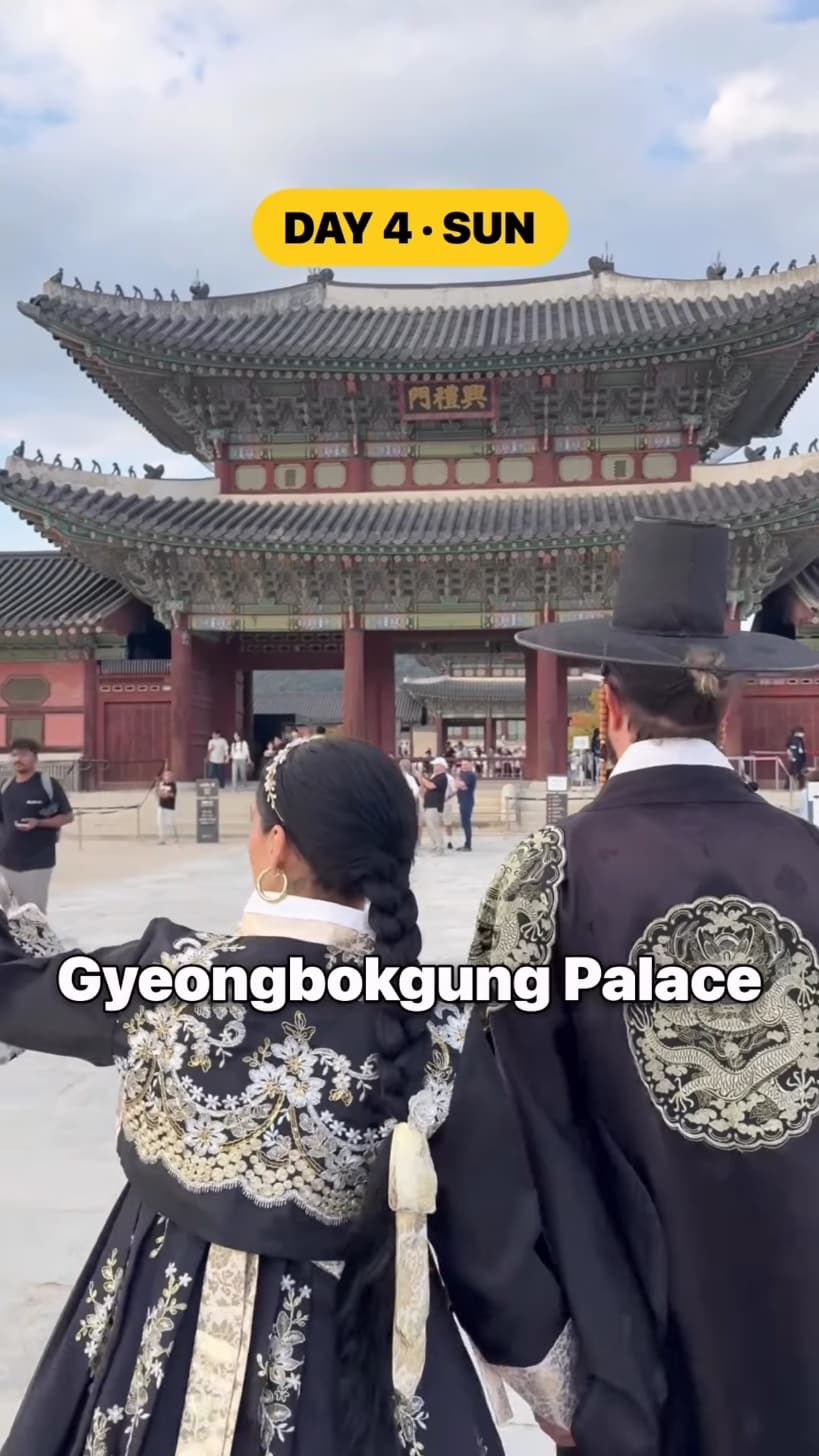 Kyle Istook and his partner in hanbok, walking toward Heungnyemun gate at Gyeongbokgung Palace.