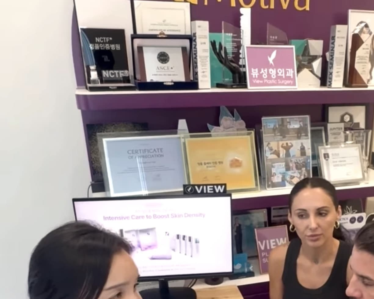 A doctor at View Plastic Surgery consulting with two patients.